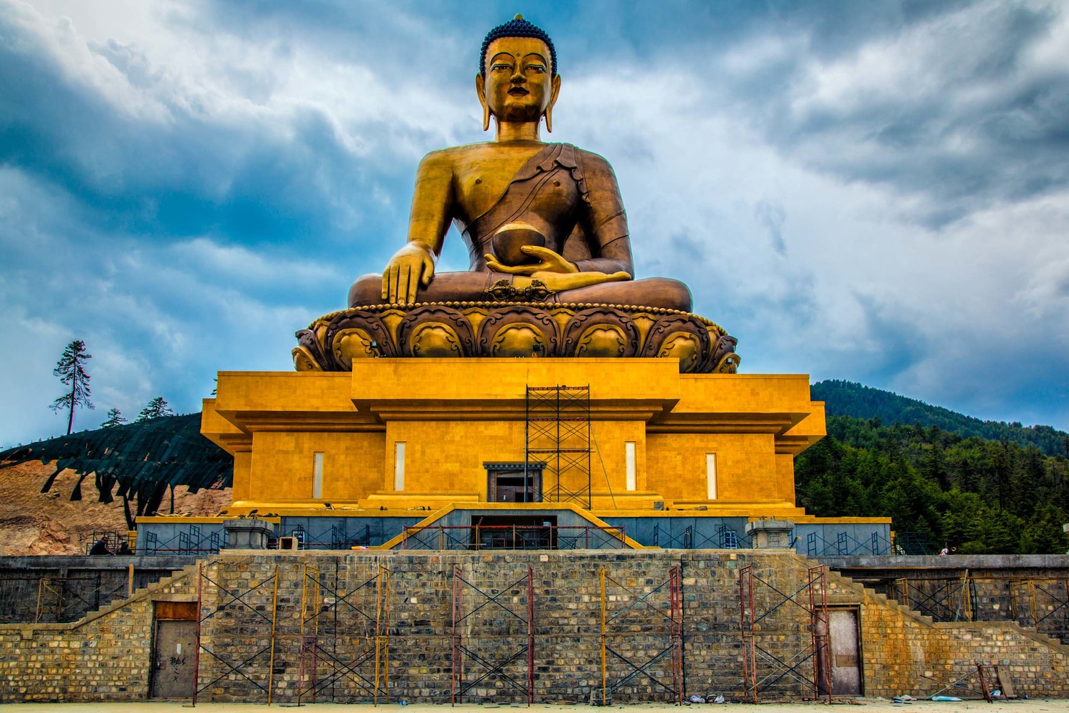 Towering in at a height of 169 ft (51.5m), this is one big Shakyamuni Buddha statue that is being built. Made of bronze and gilded in gold, it will house 100,000 8-inch-tall and 25,000 12-inch-tall statues of Buddha also made of bronze and gilded in gold. Situated on the side of a mountain, the Buddha overlooks the southern approach into Thimphu. 

The views looking down into the valley are splendid, and like most Buddhist temples and monuments, you can feel you've escaped from the hustle and bustle of the city. Not that, Thimphu is exactly a vast metropolitan area offering anonymity to the countless souls going about their daily business, but it's still an escape to a grand viewpoint with a touch of serenity. 

Elevation: 8,831 ft.